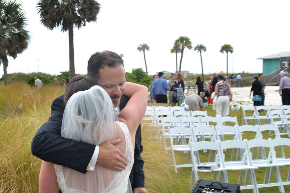 Rev. Adams hugging a recent bride at Margaritaville in Pensacola Beach Florida