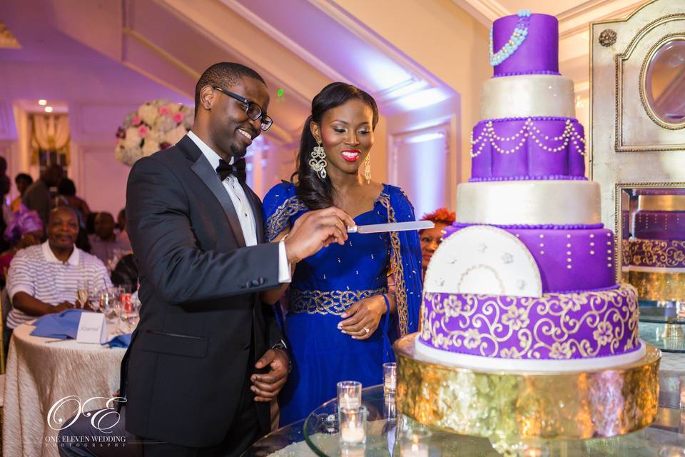 Couple cutting ornate cake