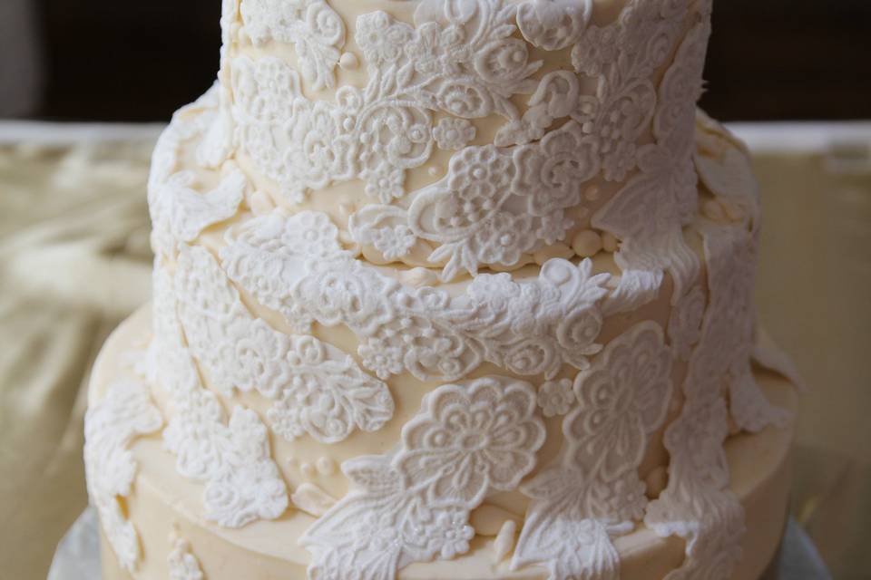 Hand Pressed Fondant Lace To Match Wedding Dress, Laid On Ivory Buttercream, And Accented With A Satin Ribbon.