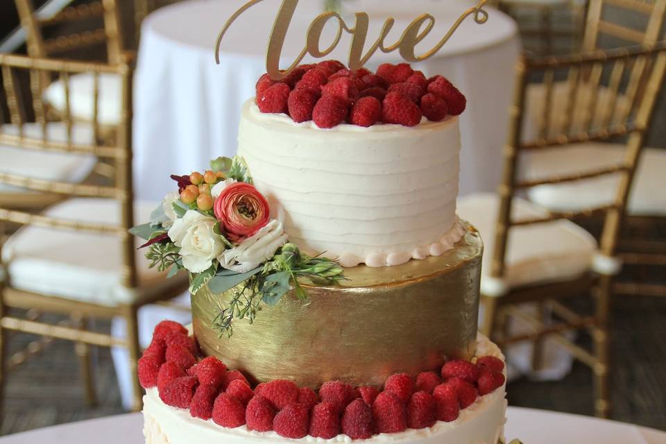 Rustic Chic Wedding Cake, Gold Painted Fondant Layer, Topped With Fresh Raspberries, And Fresh Flowers.