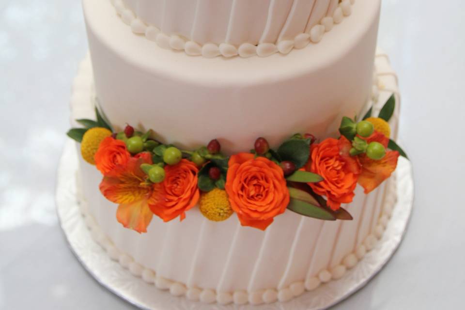 Fondant Strips Cover Wedding Tiers And Fresh Flowers As Decoration.
