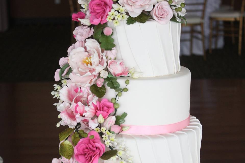 Fondant Strips Cover Wedding Tiers And Handmade Sugar Flowers As Decoration.