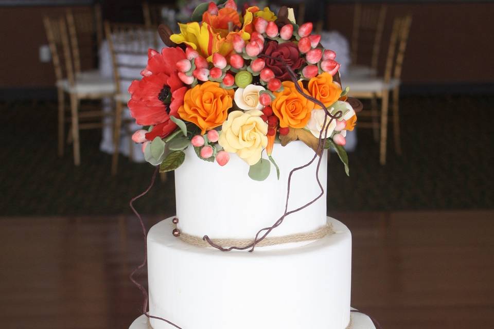 Fondant Covered Tiers, Rustic Ribbon, And Handcrafted Sugar Flowers.