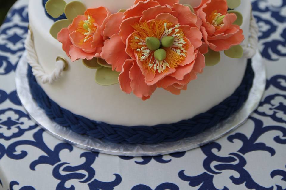 White Fondant Covered Tiers, With Fondant Braided Ropes, And Handcrafted Sugar Flowers
