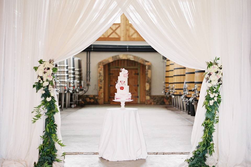 Sweetness all around. White crushed sheer frames this cake table for an extra treat.