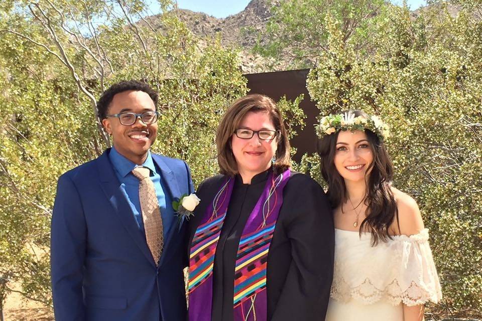 Happy officiant with newlyweds