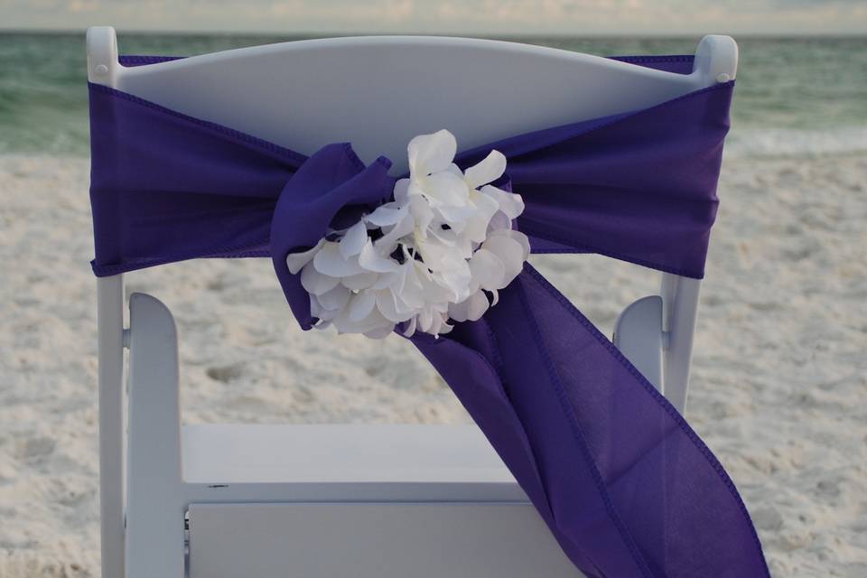 Purple sash with white flower