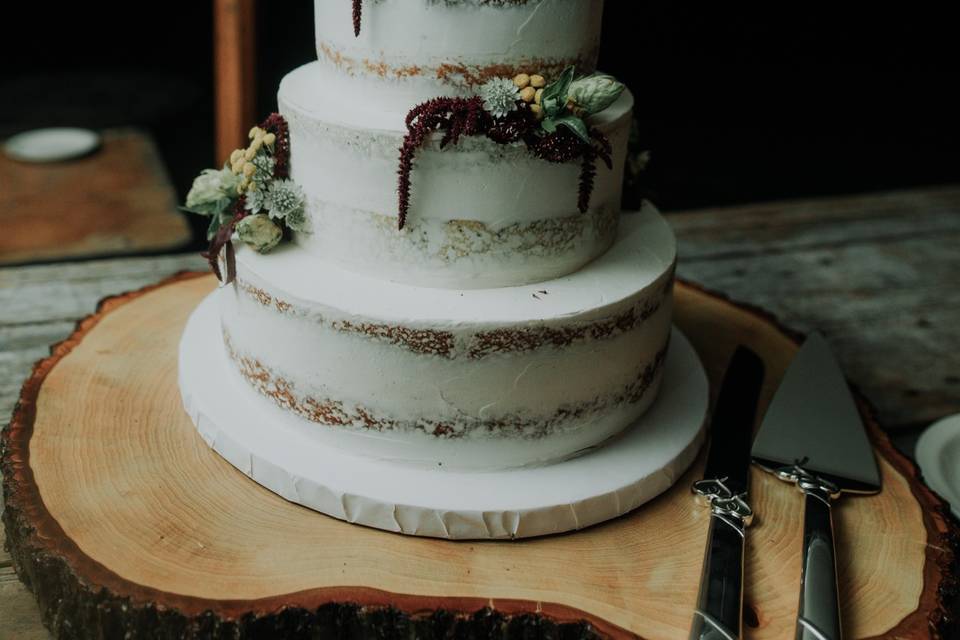 Naked cake with red flower topper