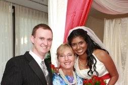 The newlyweds with the wedding officiant