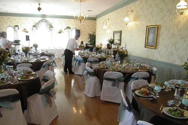 Tables and chairs are provided.  This shows the room set up for a formal sit down meal.