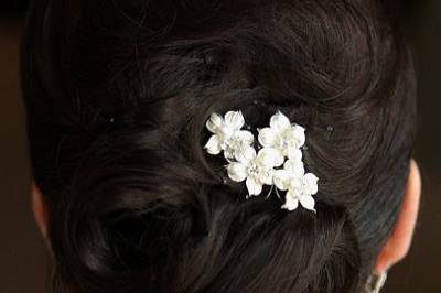 Small flowers tucked into low bun
