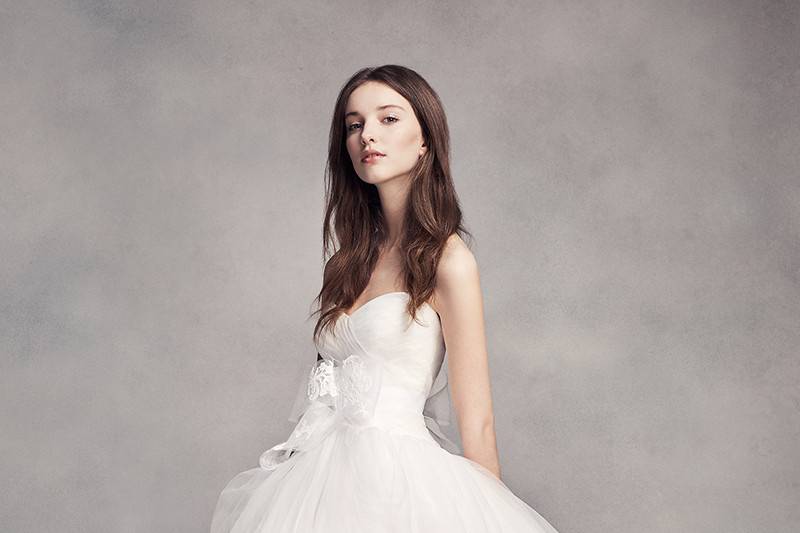 Style VW351312 <br> Lace and tulle sheath gown with illusion neckline, cap sleeves, and corded lace appliqués and organza flowers on bodice.