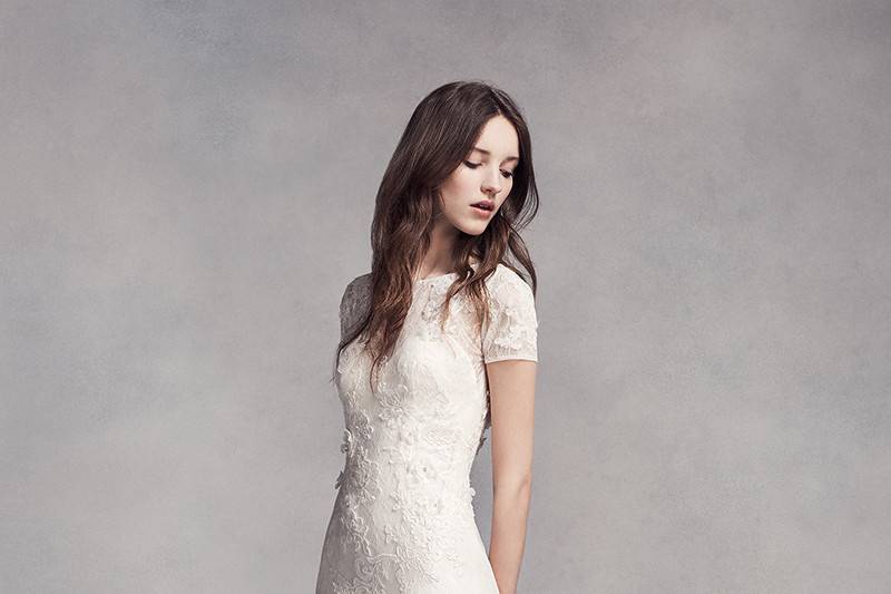 White by Vera Wang Style VW351312	<br>	Lace and tulle sheath gown with illusion neckline, cap sleeves, and corded lace appliqués and organza flowers. TK train.