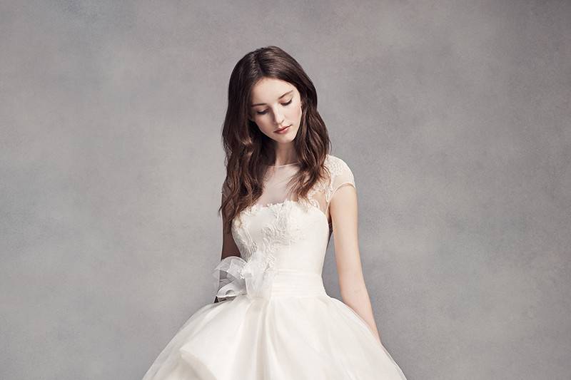 White by Vera Wang Style VW351315	<br>	Textured organza ball gown with lace appliqués on illusion neckline, peplum detail, and veiled tulle skirt.
