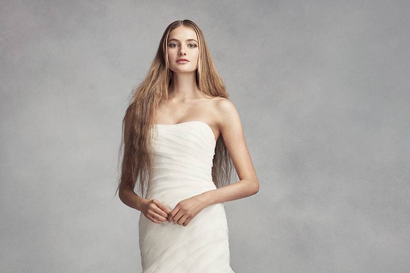 White by Vera Wang Style VW351395	<br>	Organza trumpet gown with draped bodice and dramatic ruffled skirt with rosette detail. Chapel train.