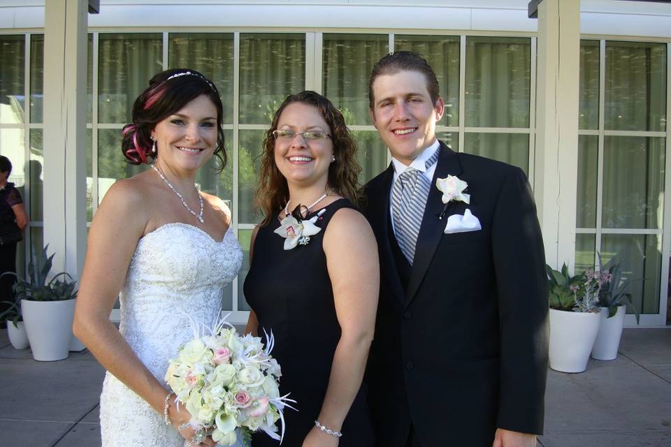 Newlywed couple and the wedding officiant