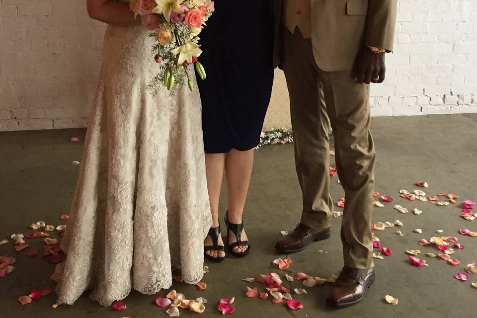 Post-ceremony photo of the officiant and newlyweds