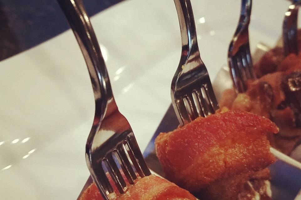 Blue Cheese Stuffed Dates, Wrapped with Bacon and served on a Silver Fork