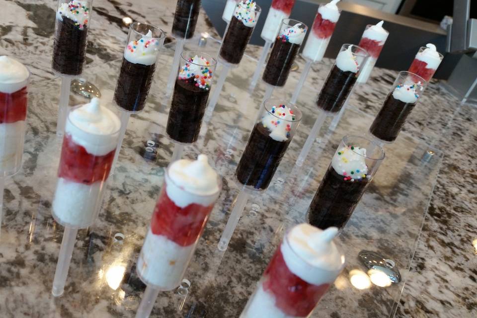 Mini dessert pushpops, displayed here are chocolate cupcake with sprinkles and strawberry shortcake pushpops