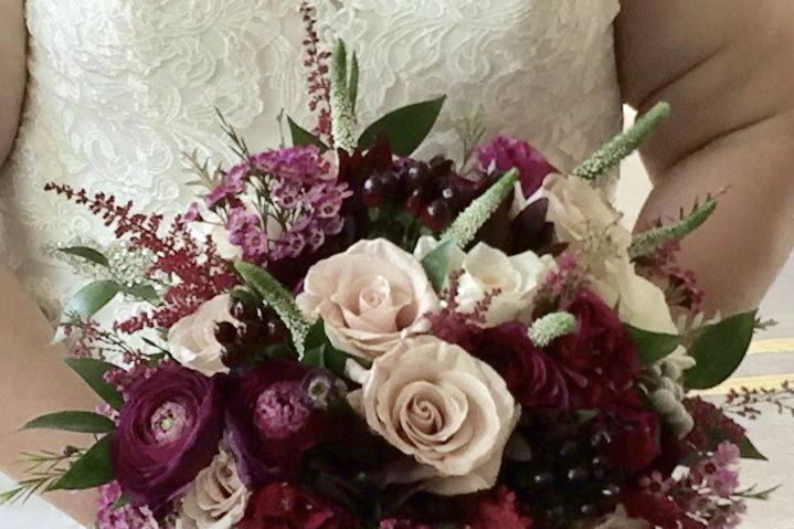 Rich and vibrant plum shades pared with blush roses are a stunning combination .