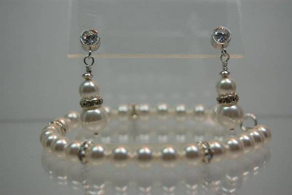 This elegant bracelet of 8mm Swarovski Crystal Pearls and Rhinestone spacers is set with a sterling silver toggle clasp. The earrings are brilliant cut Cubic Zirconia back-set in an anti-tarnish treated sterling silver ear stud and set with rhinestone spacers.