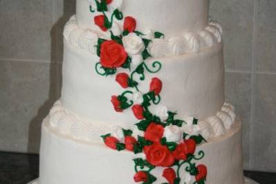 Three-tiered cake frosted in buttercream with cascading buttercream roses