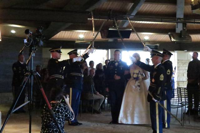 A Sharp Dj Service with a Saber Guard at a Military wedding.