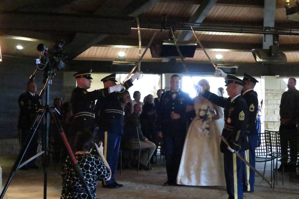 A Sharp Dj Service with a Saber Guard at a Military wedding.