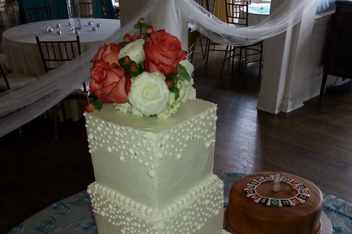 White square wedding cake with soft pastel roses