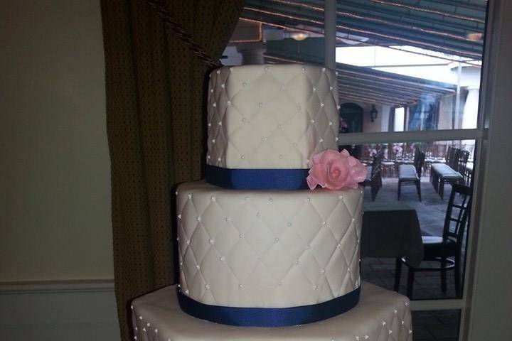 Three tier wedding cake with blue lining