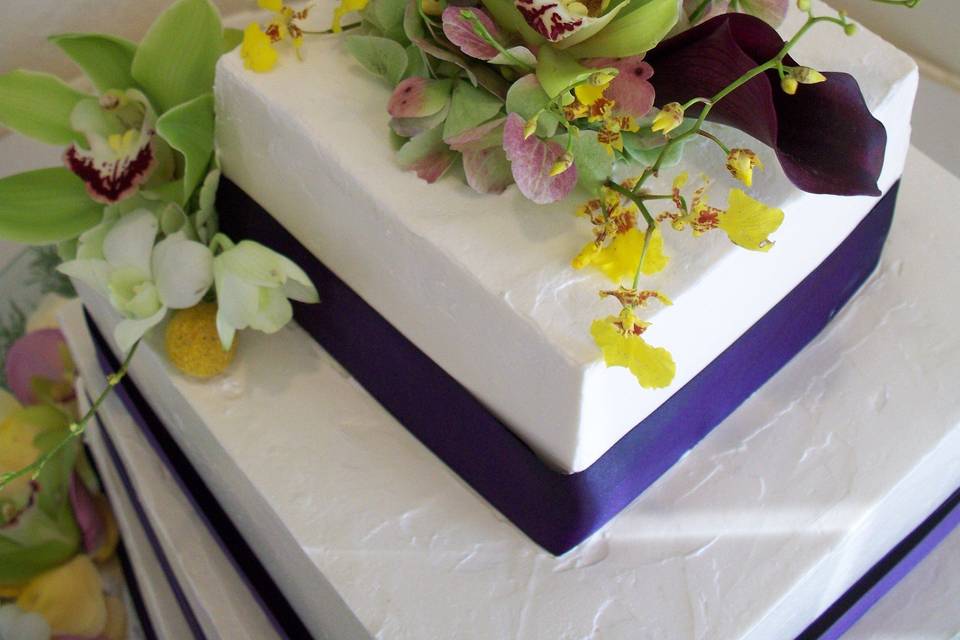 Four tier wedding cake topped with flowers