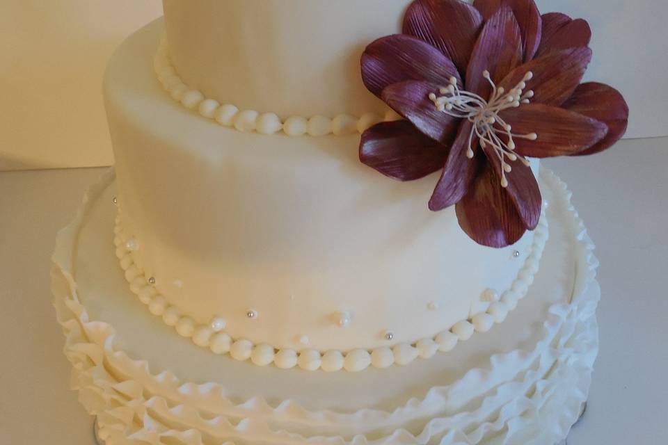 Three tier wedding cake with chocolate flower