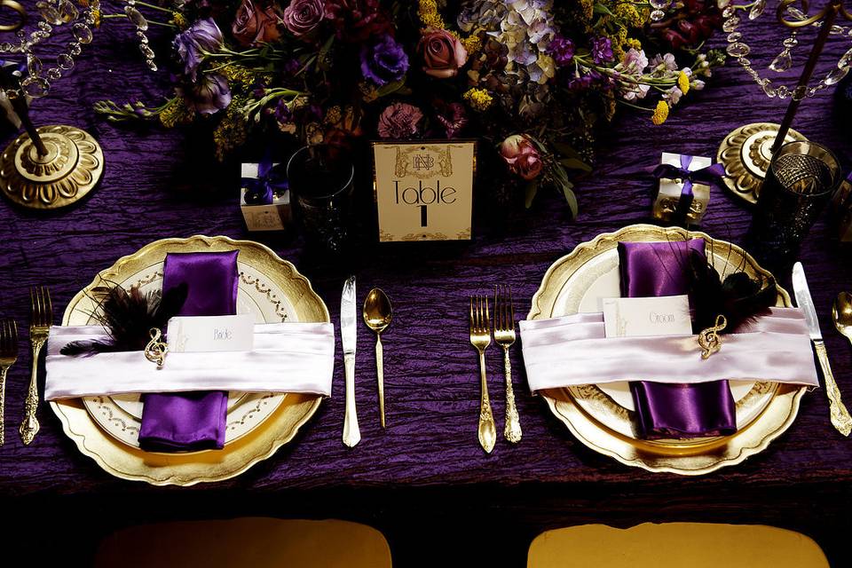 Kate Ryan Linens champagne taffeta tablecloth in the background for the grooms cake table and the main cake table has pale champagne crushed taffeta with pale champagne floral embroidery with sequins overlays. Photography by: Aaron Lockwood