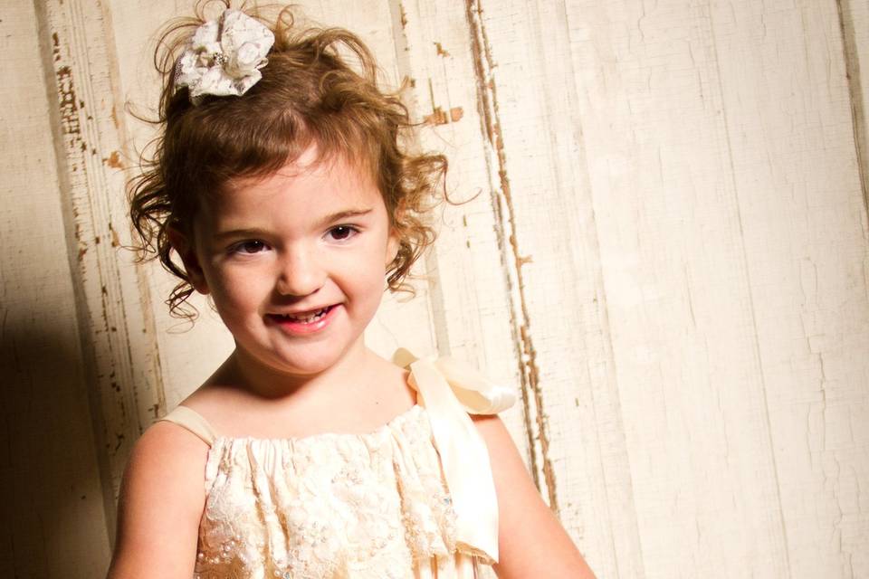 Custom made flower girl dress with lace from grandmother's dress for a romantic look.