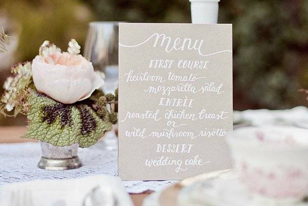 The Megan Suite - A simple hand-lettered menu with white ink on kraft paper
(Photo courtesy of Retrospect Images)