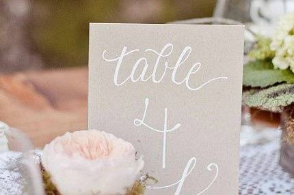 Simple, but lovely table numbers with white ink on kraft paper
(Photo courtesy of Retrospect Images)