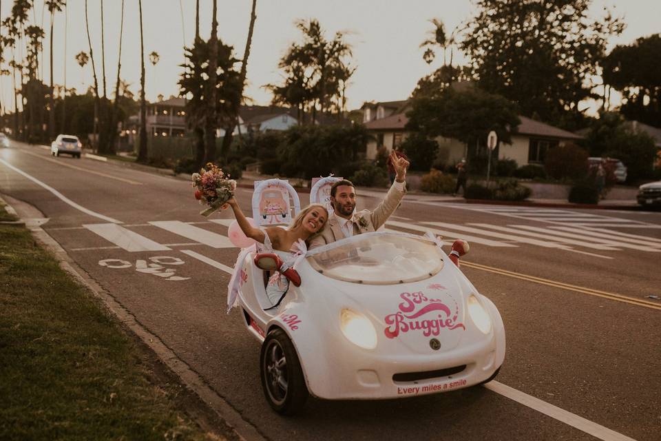 Couple driving away in buggy