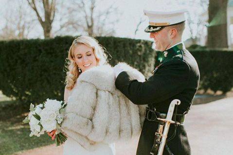 Putting his bride's coat on