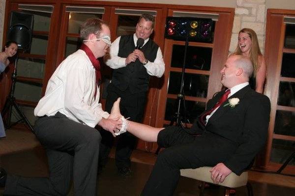 Guy who caught the garter thinks he is placing it on the girl who caught the bouquet...Surprise!