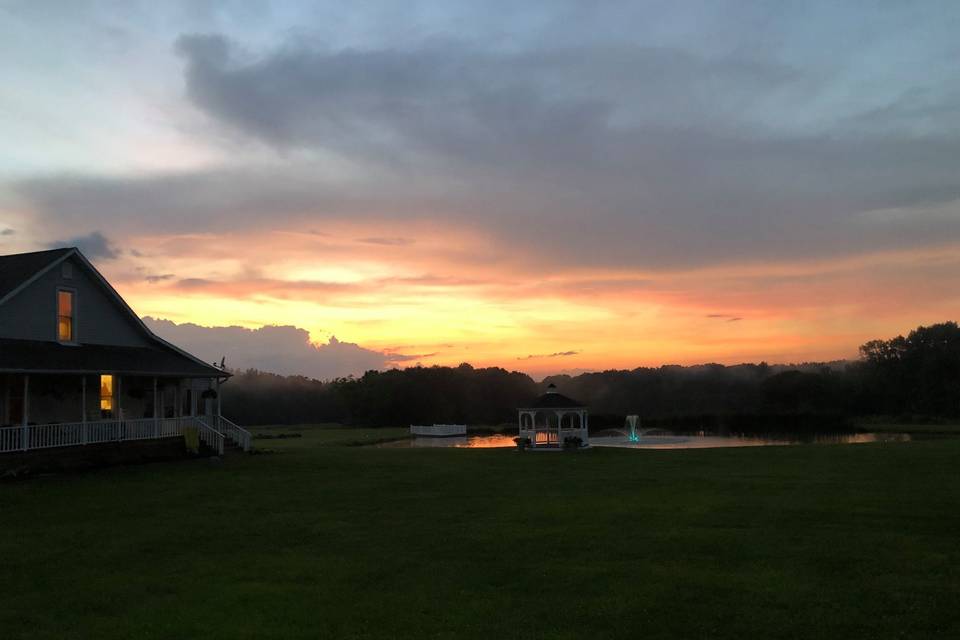 House, gazebo & pond at sunset