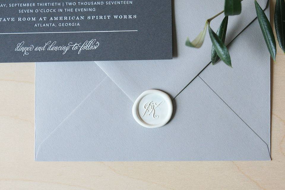 Wedding invitation with monogram wax seal.