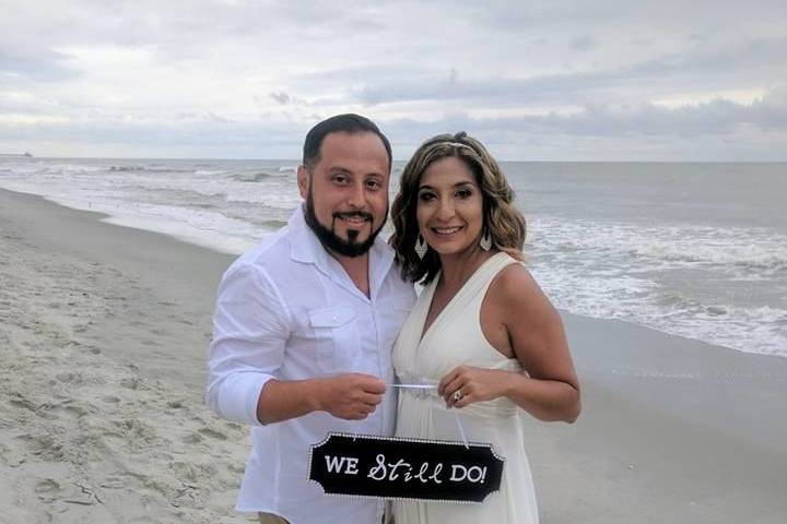 Newlyweds holding up the sign