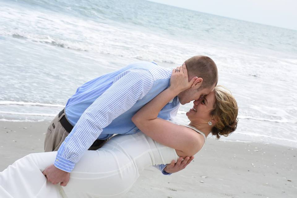 Groom dips his bride