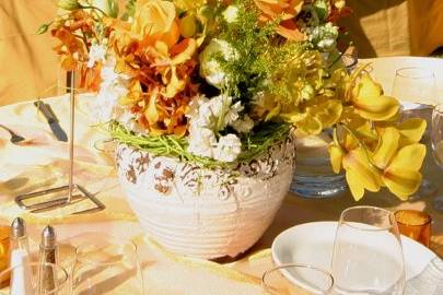 Mixed Organic summer flowers in hand made ceramic pots accent the vineyard setting