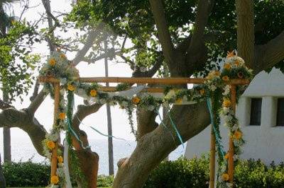 Seashells and summer flowers accent our custom Chuppah placed above the breaking surf in So. Cal