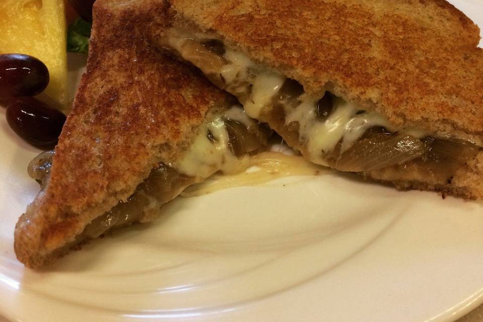 French onion grilled cheese with mozzarella on grilled wheat with a side of French onion soup broth for dipping