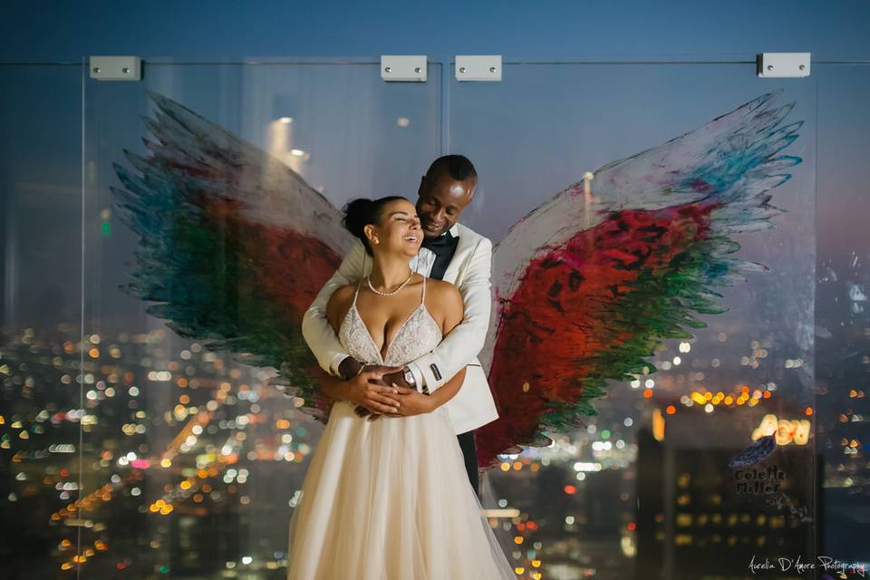 Newlyweds and glass wing backdrop