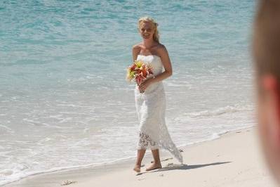 Bride walking along the shore