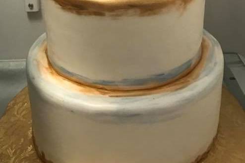 Four tier white and gold cake
