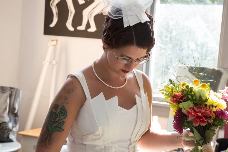 Here is a detail of the bride showing the art deco bodice with shoulder straps. On her head is a jaunty veil made to match the layers of the bodice.
